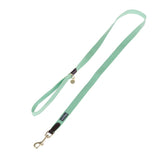 Green dog lead with gold-coloured snap hook and brown leather accents, brand label visible.