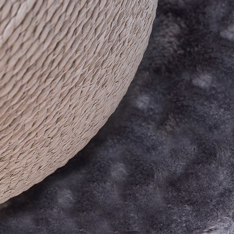 Close-up of a scratching post part with braided rope and soft grey fabric base.