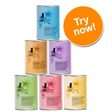 Six tins of cat finefood in assorted colours and flavours with a large orange circle displaying the text 'Try now!'