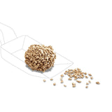 Image of a compressed food ball with loose food pieces, shown on a scoop.
