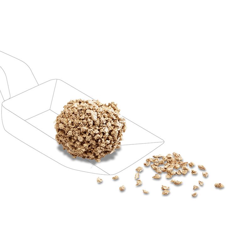 Image of a compressed food ball with loose food pieces, shown on a scoop.