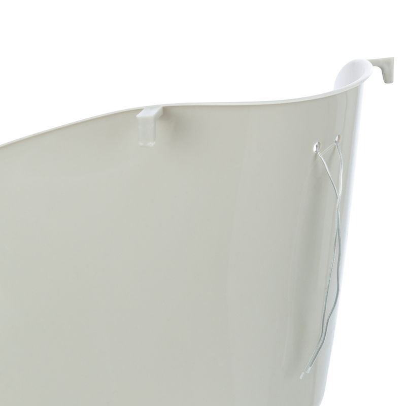 Close-up view of a white plastic container with hook and wire attachment on the side.