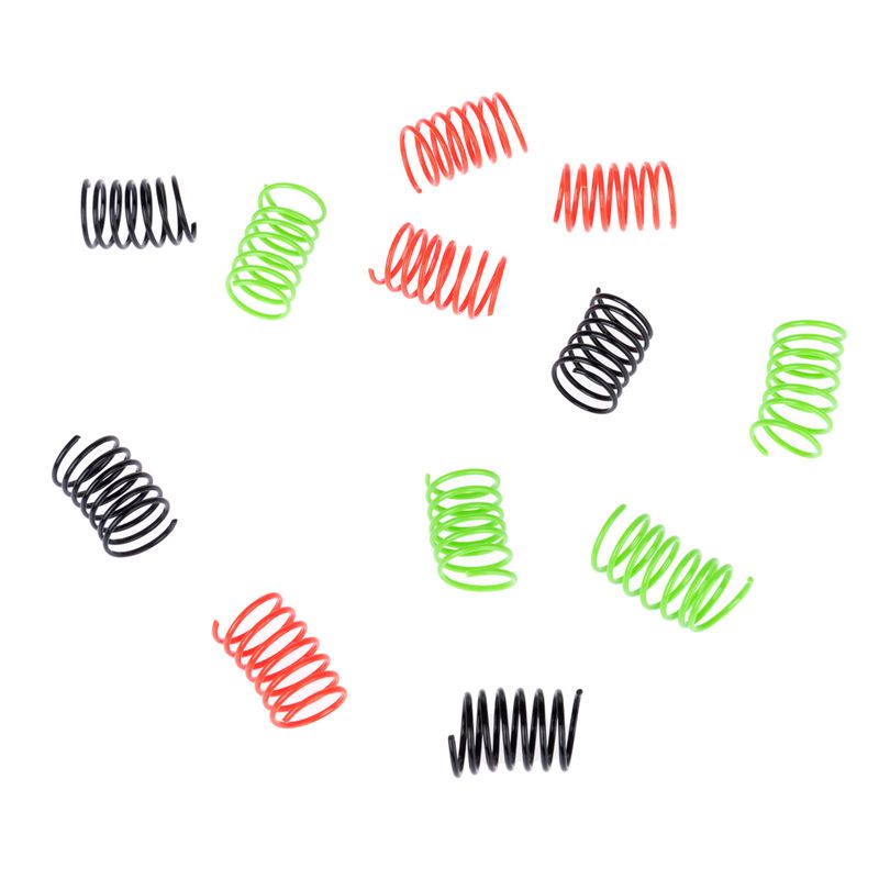 Assorted metal springs in black, green and red colours on a white background. Multiple pieces shown, each coiled and cylindrical.