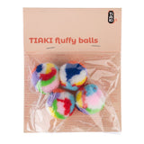 TIAKI fluffy balls, colourful fluffy balls in a transparent package. Brand name TIAKI visible on the packaging.