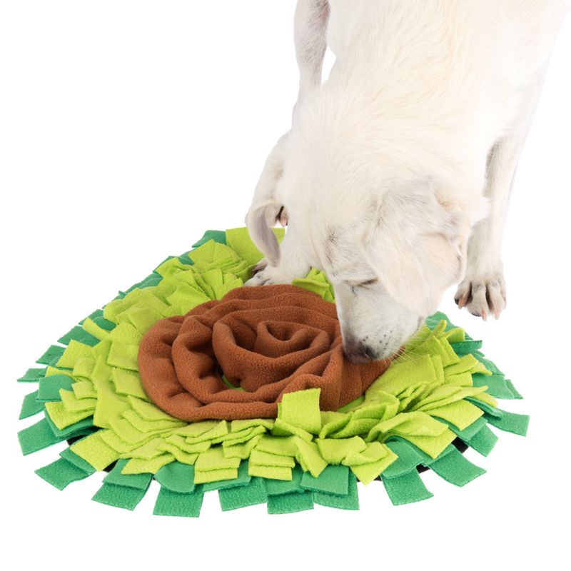 Dog sniffs a green and brown fabric snuffle mat, suitable for search games and activity.