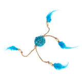 Toy made of braided rope with a blue ball in the centre and four blue feathers at the ends, connected by wooden beads.
