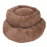 Round, brown pet bed made of soft plush material with raised edge for extra comfort.