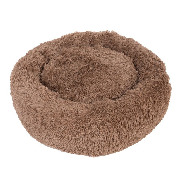 Round, brown cuddly bed with soft plush material. Ideal for pets to relax and sleep.