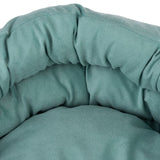 Close-up of a padded green fabric bed with a soft surface.