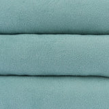 Close-up of turquoise fabric with fine knit texture, suitable for pet products or accessories.