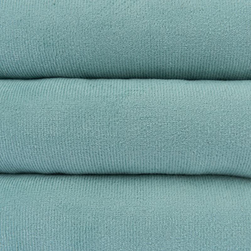 Close-up of turquoise fabric with fine knit texture, suitable for pet products or accessories.