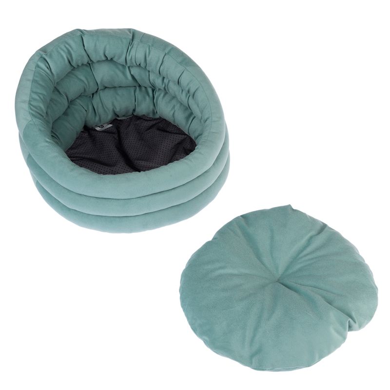 Round, padded pet bed in turquoise with removable cushion. Black, breathable inner material.