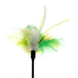 Toy with green, yellow and white feathers and decorative ribbons on a black rod.