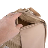 Beige transport bag with mesh opening and zip, hand showing the opening.