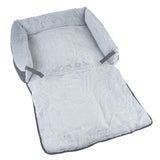 Grey, soft dog bed with fold-out lying surface and raised edge. Material: plush and fabric.