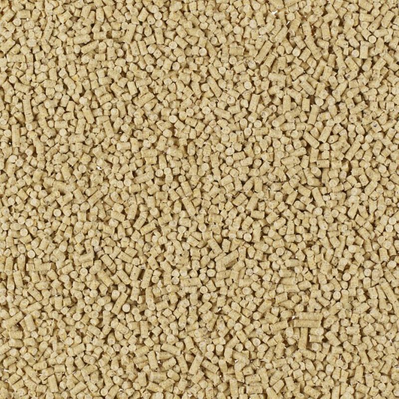 Close-up of small, beige pellets. Product description for pet food or bedding.