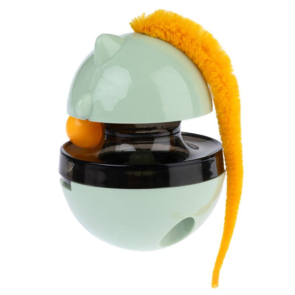 Toy in ball shape with green casing, black middle section and yellow plush tail. Visible opening for treats or food.