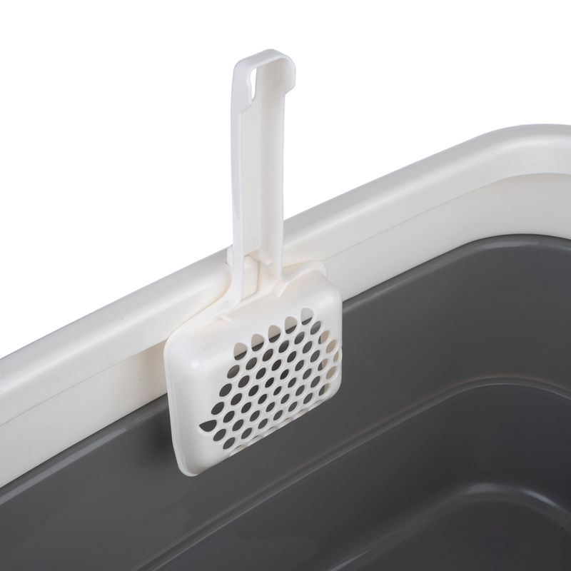 White litter scoop holder, hooked onto the edge of a grey cat litter tray.