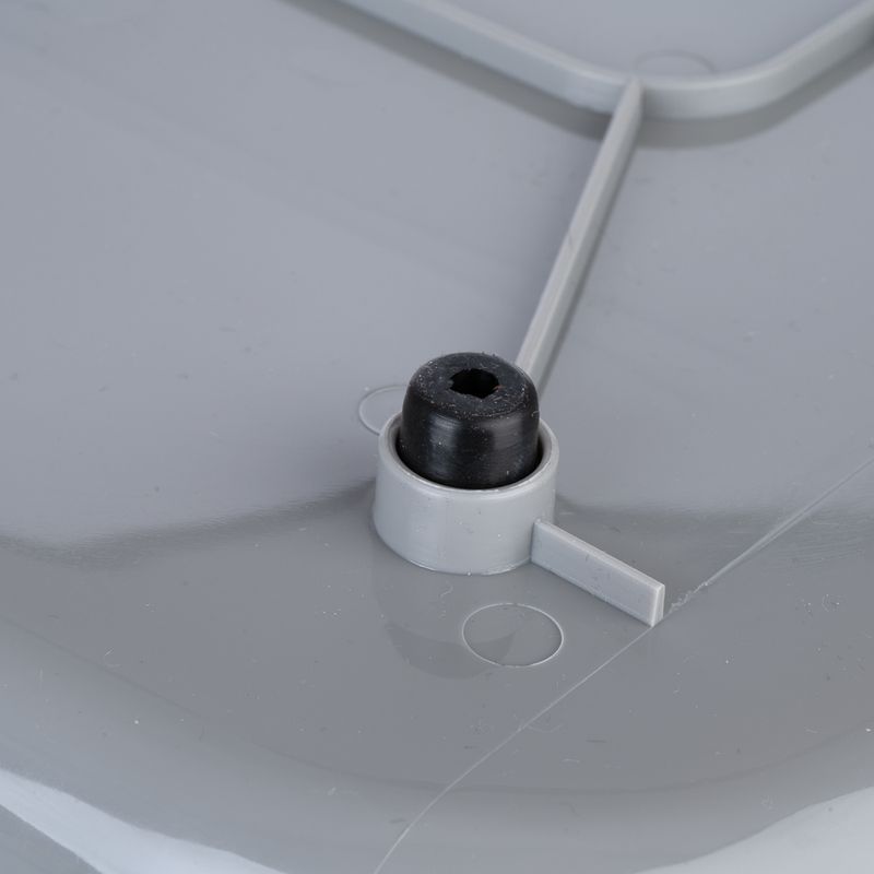 Close-up of a grey plastic lid with black rubber stopper and fastening element.