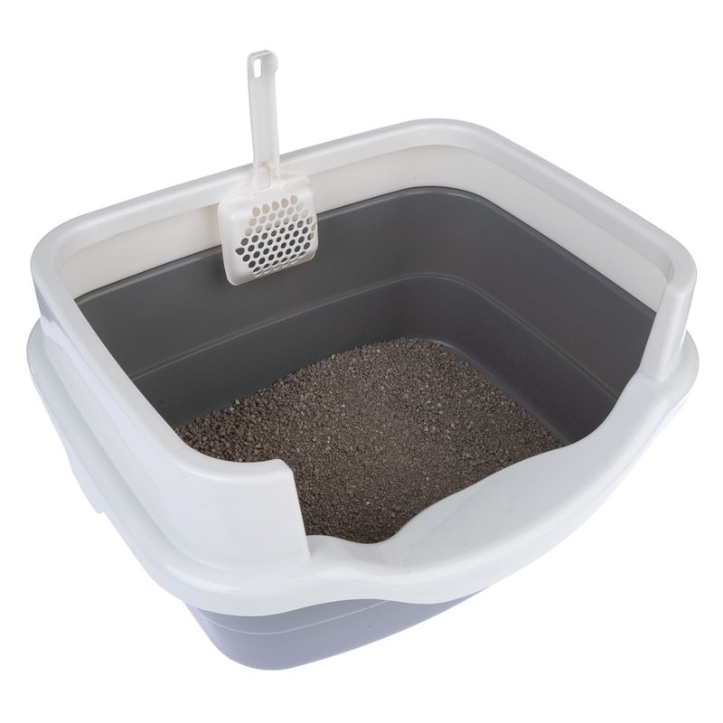 Cat litter tray with grey base, white rim and integrated litter scoop. Filled with cat litter.