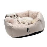 Tiaki dog bed in beige with soft plush lining, small white dog lying inside.