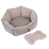 Beige, round cuddly bed with soft plush edge and matching bone-shaped plush toy. Visible logo: TIAKI.