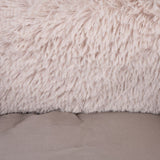 Close-up of soft beige faux fur and smooth fabric in taupe-coloured design.