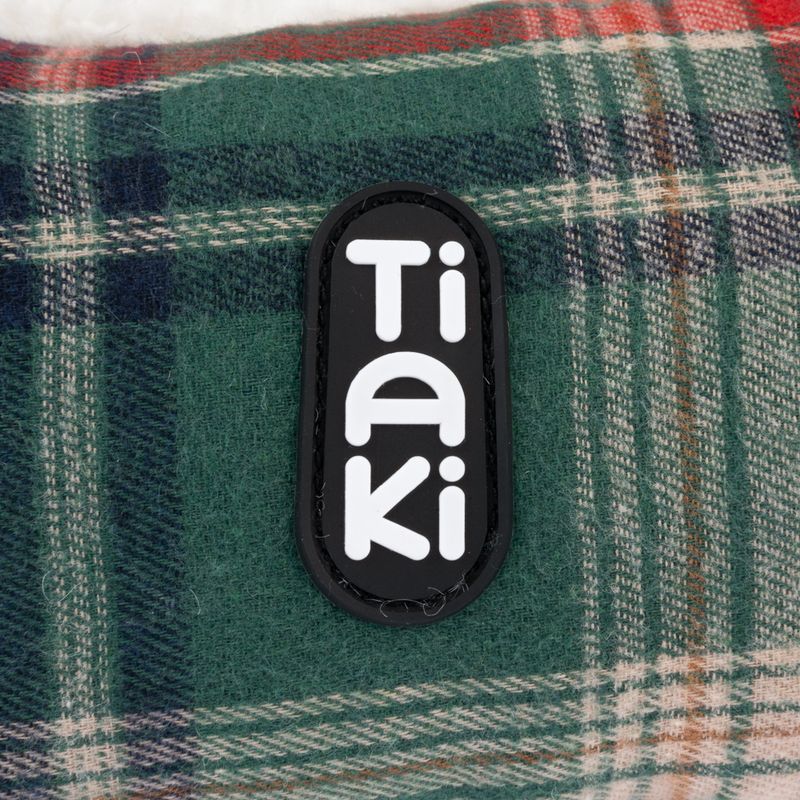 Tiaki logo on green checked fabric.