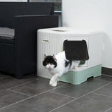 Cat toilet with side entry, white-green, cat exiting through the flap. Suitable for discreet placement in living areas.