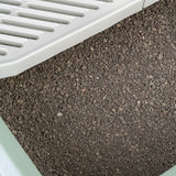 Close-up of cat litter made of brown granules in a litter tray with a white plastic sieve.