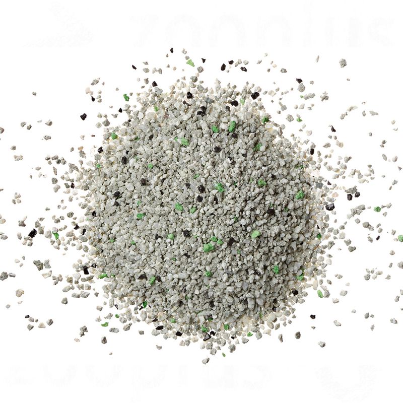 Close-up of cat litter with grey, black and green granules.