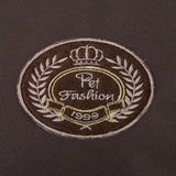 Pet Fashion 1999, embroidered emblem with crown and laurel wreath on brown fabric.
