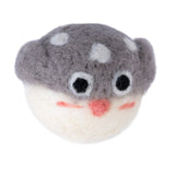Felt toy in the shape of a grey mushroom with white spots, eyes and a red mouth. Handmade from felt material.