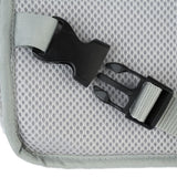Close-up of a black snap fastener on grey mesh material with attached webbing.