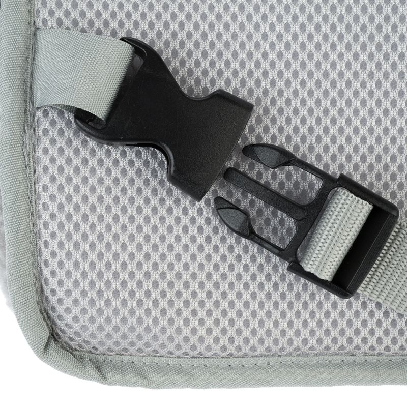 Close-up of a black snap fastener on grey mesh material with attached webbing.
