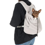 Grey pet backpack with soft fabric, worn by a person. Small dog sits securely in the bag. Adjustable straps visible.