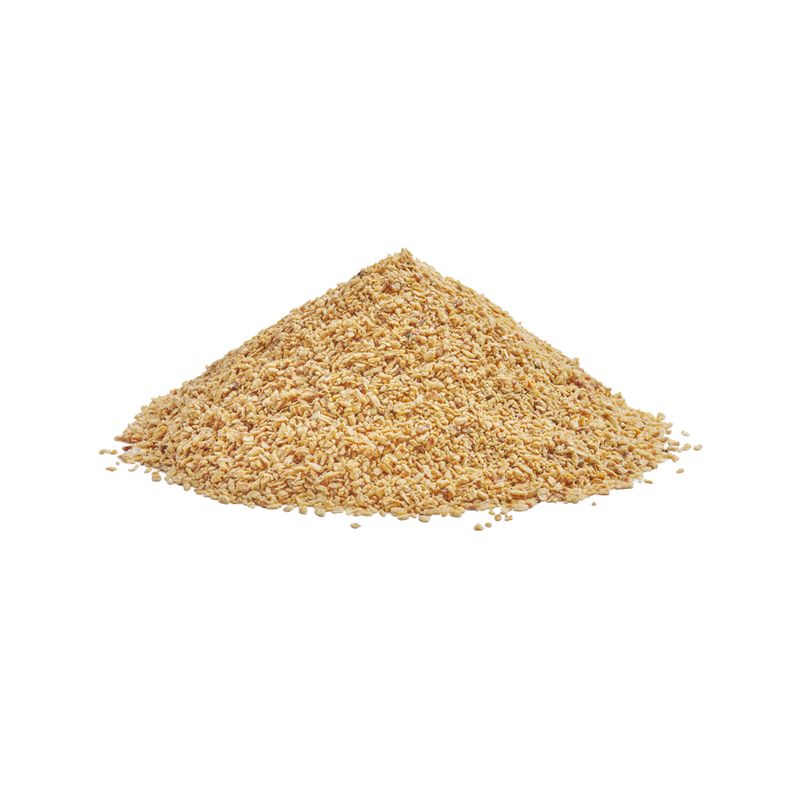 Pile of yellowish-brown granule pieces, possibly pet food or bedding.