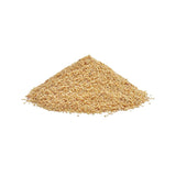 Pile of yellowish-brown granule pieces, possibly pet food or bedding.