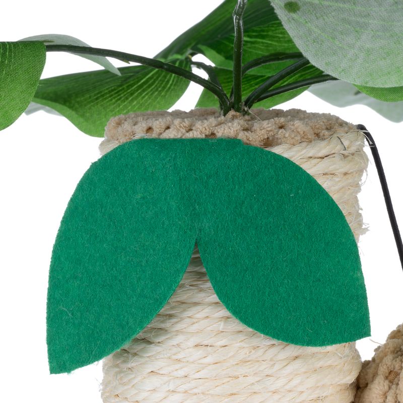 Close-up of a toy with a green felt leaf and sisal rope, decorated with artificial leaves.