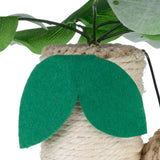 Close-up of a toy with a green felt leaf and sisal rope, decorated with artificial leaves.