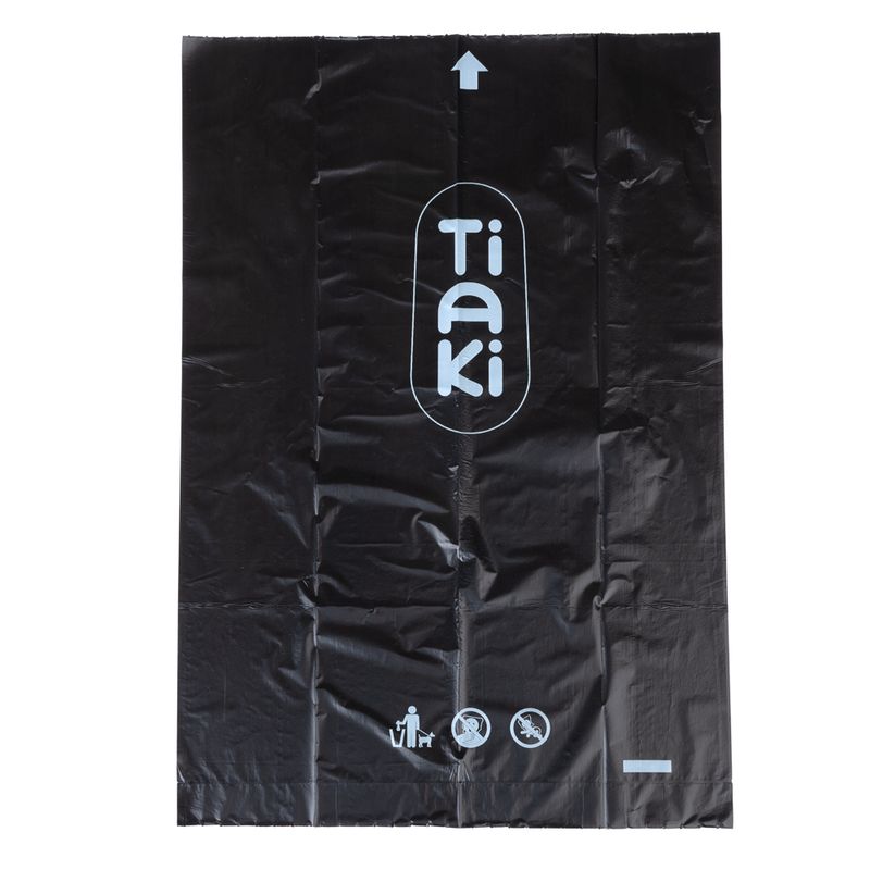 Tiaki dog waste bags made of black plastic with arrow indicating opening direction and disposal symbols, no animals and no plastic waste.