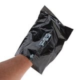 Black plastic bag with hand inside, arrow and symbol visible on the surface.