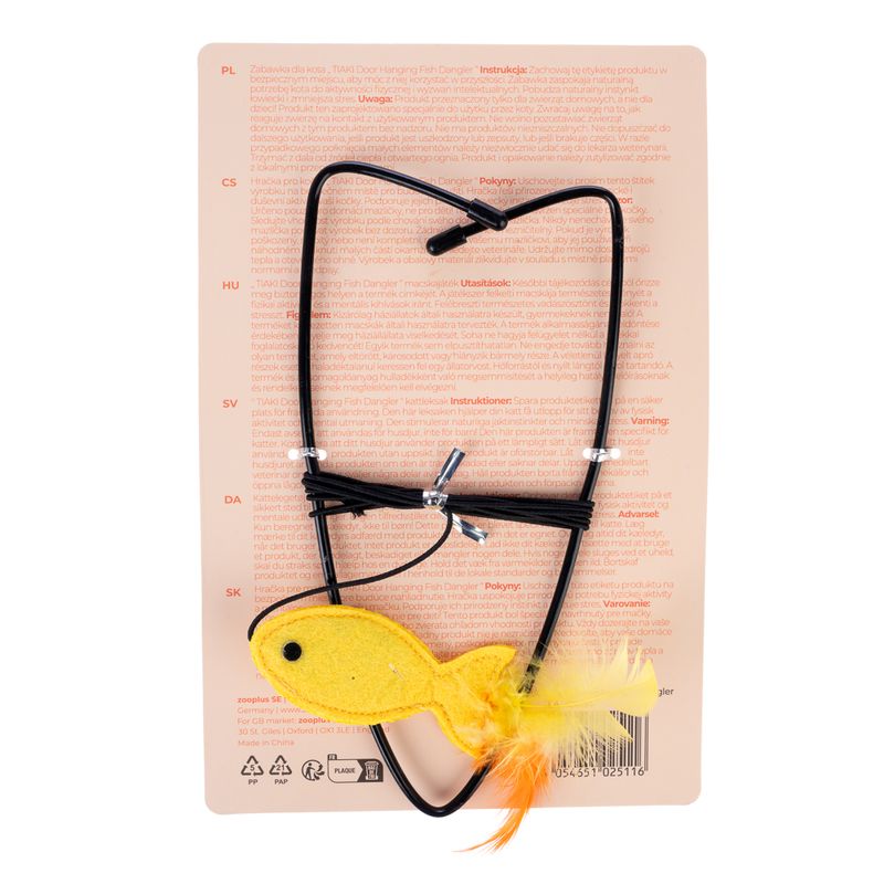 Toy for cats: yellow fish with feathers on elastic band. Instructions and warnings visible on packaging in several languages.