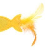 Yellow felt toy in fish shape with yellow feathers at the tail end.
