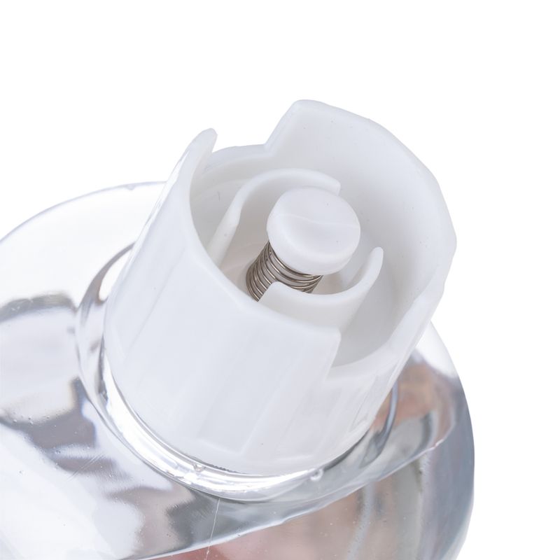 Close-up of a white spring mechanism in a transparent bottle, suitable for precise dosing of liquids.