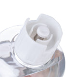 Close-up of a white spring mechanism in a transparent bottle, suitable for precise dosing of liquids.