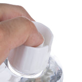 Hand turns white cap of a transparent bottle. Demonstration of product opening.
