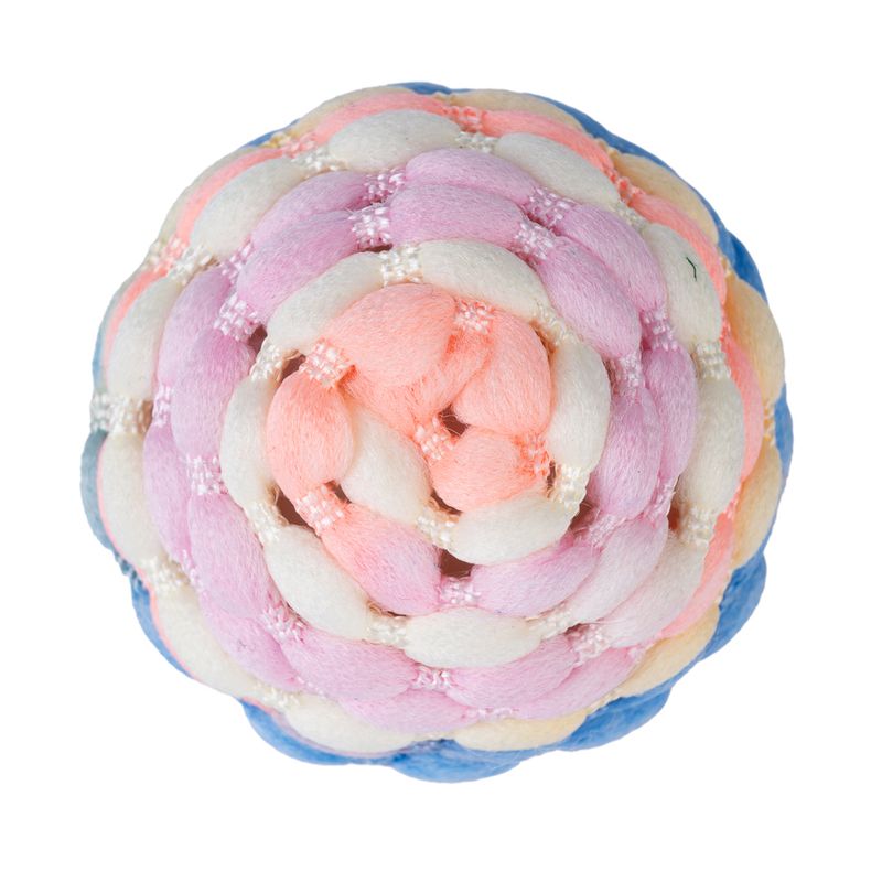Braided ball made of colourful fabric in pink, white, blue and yellow. Round design for play purposes.