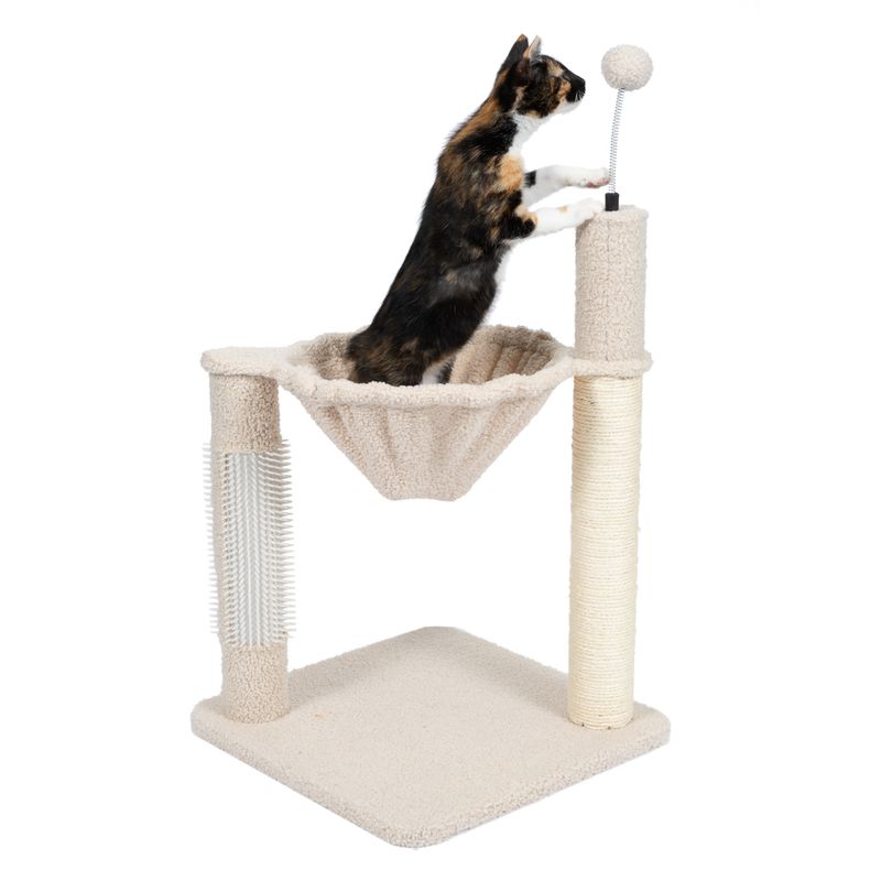 Cat tree with hammock, sisal scratching post, brush and play ball. Cat playing on the cat tree.