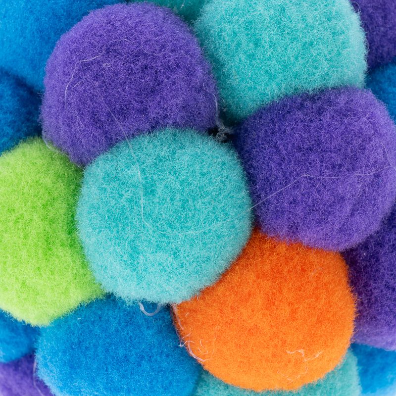 Colourful felt balls in various colours: purple, blue, green and orange. Close-up of the material.